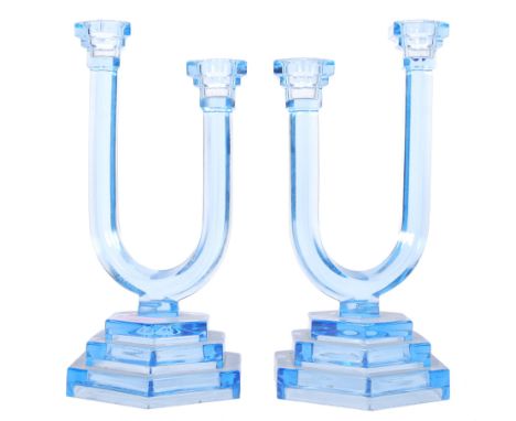 A pair of art deco 1930's antique vintage pressed glass asymmetrical double candlestick holders. The twin sconce candlesticks