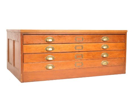 A mid 20th century retro vintage industrial large oak four drawer architects / school plan chest having brass D cup handles a