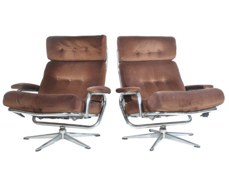 A stunning pair of retro vintage tubular chrome constructed wide lounge swivel chair / armchairs. The chairs having a spring 