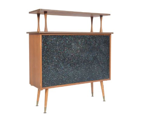 A retro vintage 1960's teak wood drinks cocktail bar. The bar having a raised tier top supported by waited teak columns, the 
