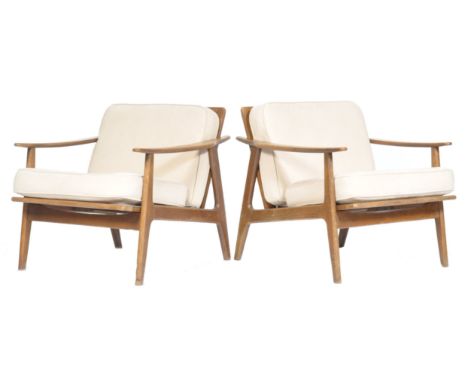 A stunning pair of retro vintage teak wood framed easy / lounge chairs / armchairs .The armchairs having angular frames with 