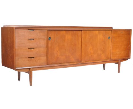 A superb Scandinavian influenced 1960's retro vintage teak wood sideboard credenza. The unit comprising of twin sliding doors