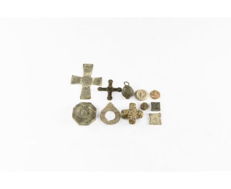 7th-11th century AD. A group of items comprising: a carved equal-armed stone cross; a large octagonal weight with a high-reli