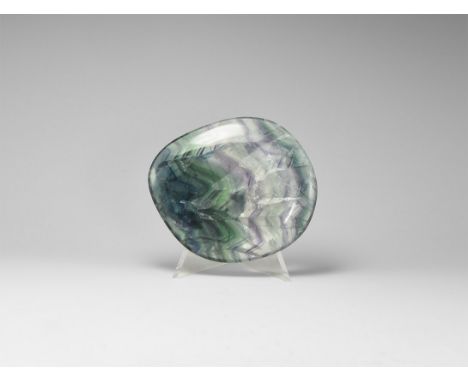 A 'touchpiece' of banded purple and white fluorite, polished all-round. See Bonewitz, Dr. Ronald Louis, Rocks & Minerals, 200