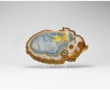 An unusual slice of agate, polished on both sides, with numerous bands and swirls, and a 'bloom' emerging on one side. See Bo