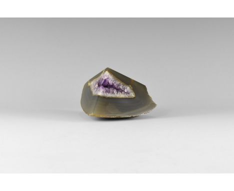 A sawn and polished quarter of an amethyst-lined agate geode, polished on both faces and with a flattened and polished base. 