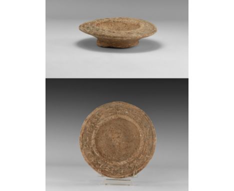 An undated archaistic ceramic bowl with pedestal base, wide flared rim decorated with antelopes and foliage.  310 grams, 13.5