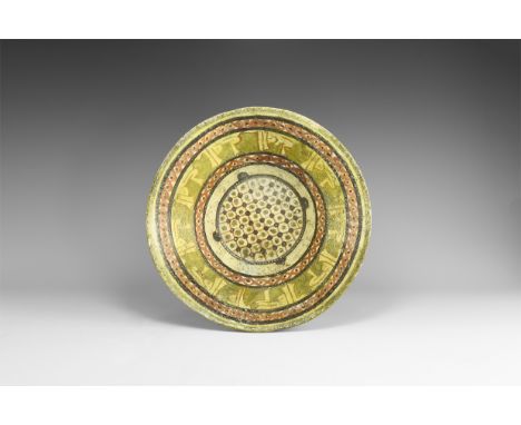 20th century AD. A glazed ceramic bowl with basal ring, concentric bands of decoration to the sidewall, running brown lozenge