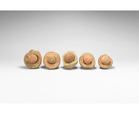 Group of five wind-rounded pebbles with their individual hollowed out 'nests', from the Kalahari Desert region, western Afric