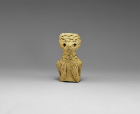 An undated archaistic ceramic figure torso of a female (?) with band of hair across the top with incised line, pinched nose a