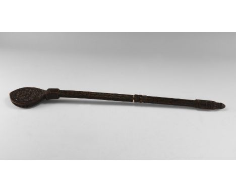 19th century AD. A wooden baton with running scrolls and foliage to the octagonal-section shaft, median beaded collar with le