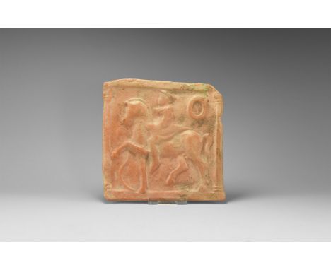5th-3rd century BC. A square ceramic plaque with male in short cloak and hat, on a horse with leg raised, snake rising up in 