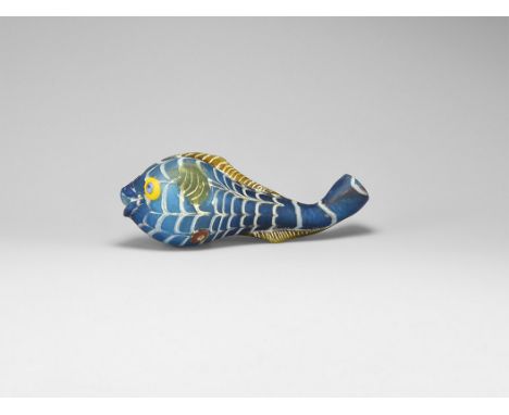20th century AD. A hollow-formed blue glass fish with dragged trail scales, applied eyes and fins.  32 grams, 10.5cm (4"). Ex