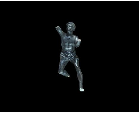 20th century AD. A cast iron(?) Art Deco figurine of an athletic male in active pose wearing a loincloth; bracket to the righ