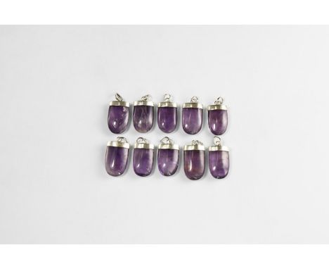 A group of ten polished amethyst pendants with silver-coloured metal caps. See Bonewitz, Dr. Ronald Louis, Rocks & Minerals, 