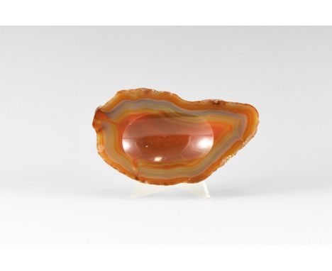 A tray carved from a tick piece of banded carnelian, with a felt back. See Bonewitz, Dr. Ronald Louis, Rocks & Minerals, 2008