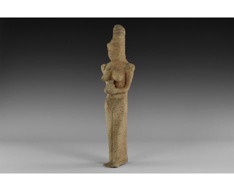 An undated archaistic ceramic figure of a female with conical striated headdress, large nose and applied eyes and lips; neckl