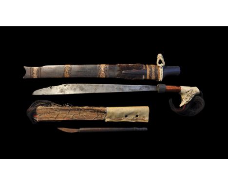 20th century AD. A mandau sword used by the Orang Ulu of East Borneo comprising a thick D-section single-edged blade with bra