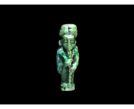 Late Period, 664-332 BC. A green glazed composition amuletic pendant of Khonsu wearing disc and crescent moon, holding a scep
