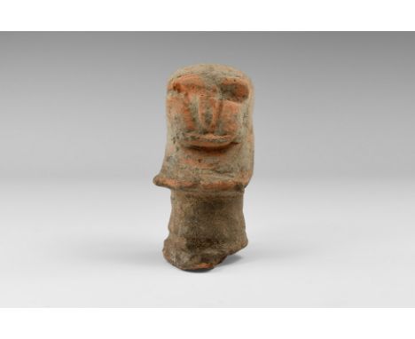 An undated archaistic ceramic stopper for a vessel in the form of a head with schematic facial features in the form of ridged