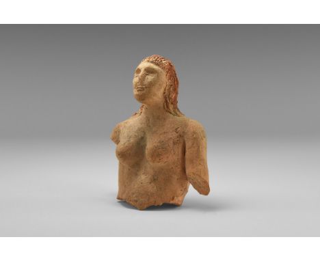 An undated archaistic ceramic fragment of a female figure, with long hair swept back over the head and falling to the shoulde