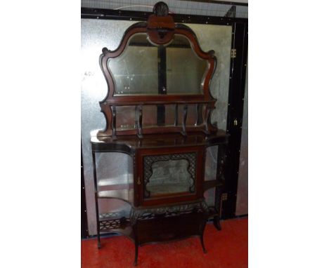 A LATE VICTORIAN CARVED MAHOGANY DISPLAY CABINET WITH A SHAPED ARCHED BEVELLED MIRROR BACK AND SHELF ABOVE, GLAZED PANELLED D