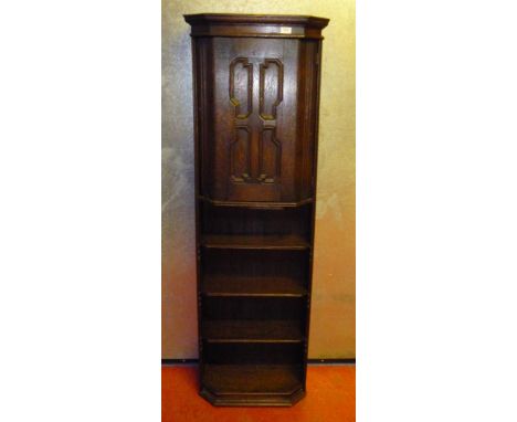 UNUSUAL OAK COCKTAIL CABINET WITH A MOULDED PANEL DOOR ABOVE WITH CANTED SIDES, SWIVEL SHELF. LABELLED ROBSON & SONS LTD, NEW