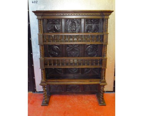 FLEMISH CARVED ELM AND BEECH THREE TIER SHELF UNIT WITH A CARVED FIGURE AND FLORAL PANELLED BACK AND SPINDLE GALLERIES FLANKE