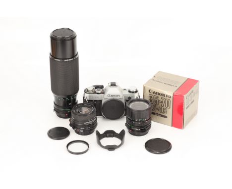 A Canon AE-1 SLR Camera, with Sigma Super-Wide II f/2.8 24mm, Canon FD f/3.5-4.5 35-70mm and Canon FD f/5.6 100-300mm lenses 