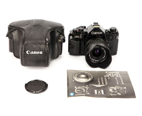 A Canon A-1 SLR Camera, with FD f/2.8 28mm lens, with case and instructions