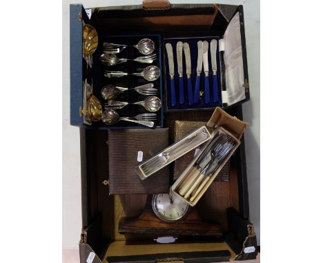 A collection of boxed cutlery sets and small Enfield oak mantle clock 