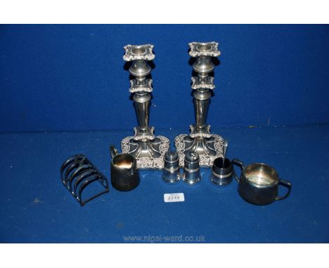 A quantity of silver plate, etc; including two silver plate candlestick holders, Walker and Hall toast rack, cruets, etc