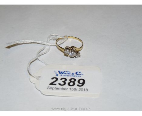 An 18ct Gold cross-over Ring set with three diamonds, one being .3 ct. approx, two being .15 ct approx., size M, 2 gms