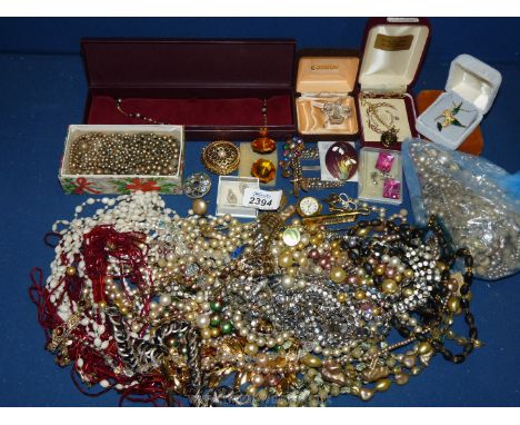 A box of costume jewellery, beads and loose beads