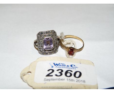 A 9ct gold ring with oval amber coloured stone and a silver amethyst ring