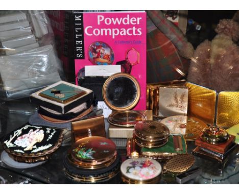 A 1950s Le Rage novelty compact the cover with clock dial and appointment themes together with a collection of assorted other