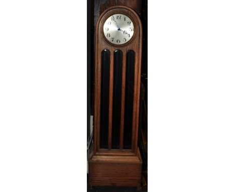 A 1920s light oak longcase clock, the glazed case incorporating a circular silvered dial marked Arabic numerals