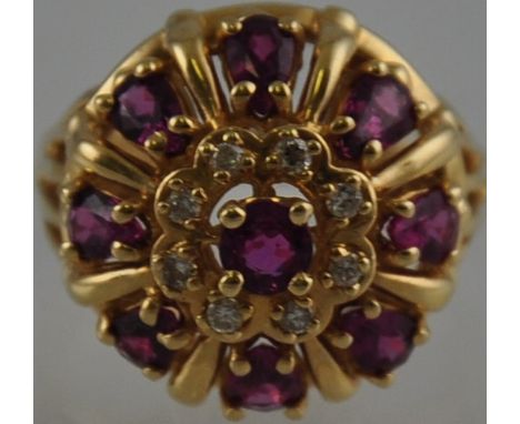 A ruby and diamond dress ring of crown form claw set in a 14k yellow gold band