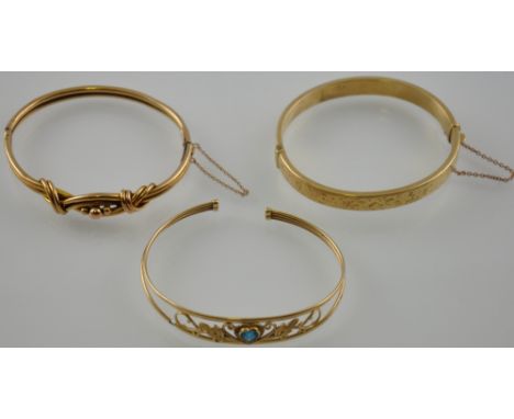 Two 9ct yellow gold hinged bangles together with one other 9ct bangle set with a heart shaped aquamarine, 26.3g gross weight