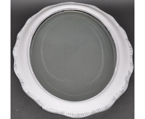 A 1920's oval bevelled wall mirror, later painted white