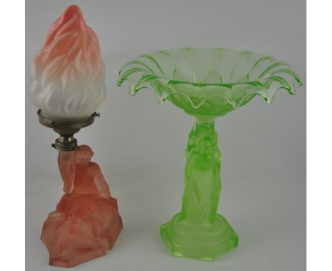 A 1950s green glass figural centrepiece together with a similar peach glass lamp base with flambe shade