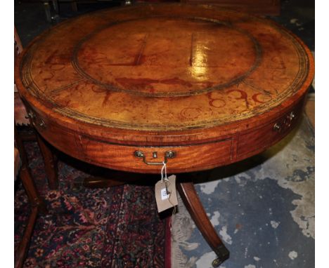 A George III Sheraton design pale mahogany drum table with revolving gilt tooled tan leather inset top over 4 fitted and 4 du