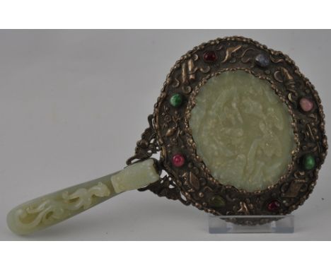 A late 19th/ early 20th Century Chinese silver and carved jade hand mirror the large oval plaque decorated with boating figur