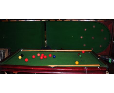 A folding bagatelle table, together with a small table snooker table with cues and balls