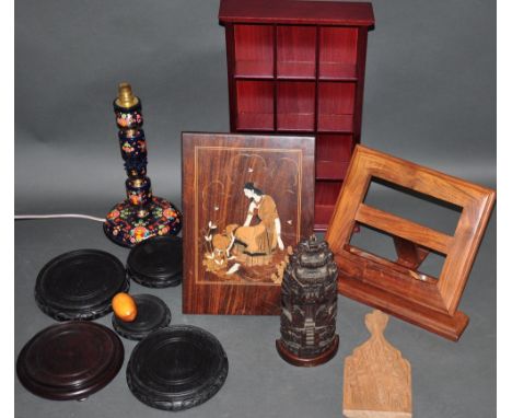 A hardwood book stand together with a small mahogany display shelf, an Indian inlaid panel, papier mache lamp base etc