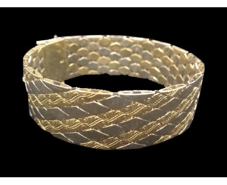 Elegant Biclor bracelet in high quality 585  (14K) yellow gold with white gold, scroll pattern,push-button clasp. Marked 585 