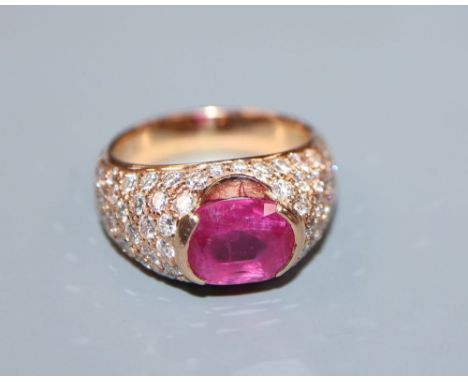 A yellow metal, ruby and diamond encrusted dress ring, size O, gross 11.3 grams.CONDITION: Ruby size approx. 8.9mm by 7.4mm. 