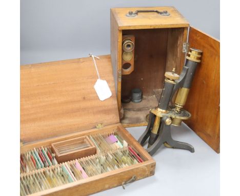 A Negretti and Zambra cased brass microscope and various specimen slides