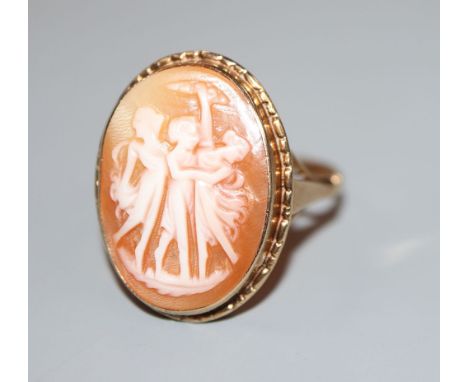 An early 20th century 9ct gold and 'Three Graces' carved oval cameo shell ring, size R, gross 3.5 grams.CONDITION: Overall co