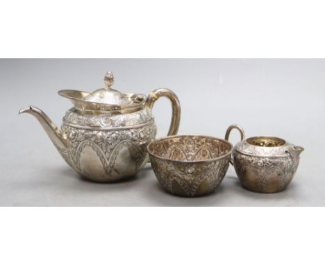 A late Victorian bachelor's embossed silver three piece tea set, Mappin &amp; Webb, Sheffield, 1895, gross 16 oz.CONDITION: H